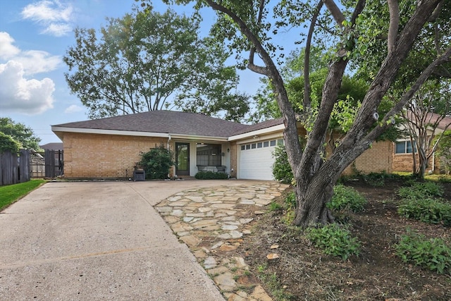 single story home with brick siding, driveway, and a garage