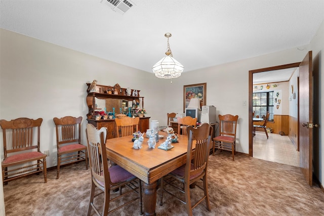 carpeted dining area with visible vents