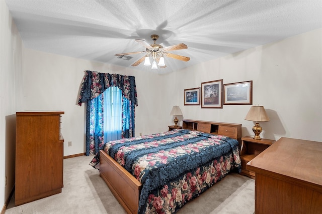 bedroom featuring ceiling fan, light carpet, and visible vents