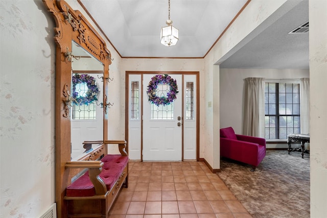 tiled entrance foyer featuring baseboards and visible vents