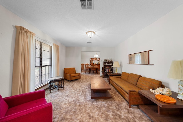 living room with visible vents and a textured ceiling