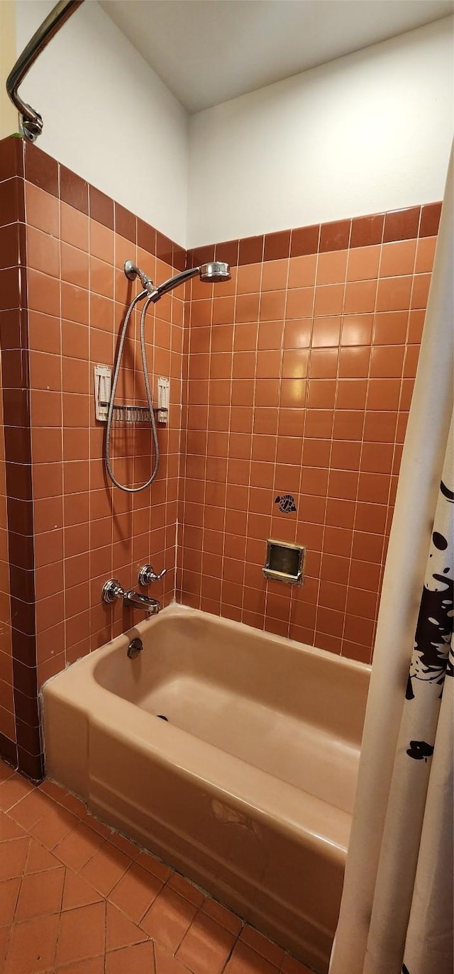 bathroom featuring tile patterned flooring and shower / tub combo