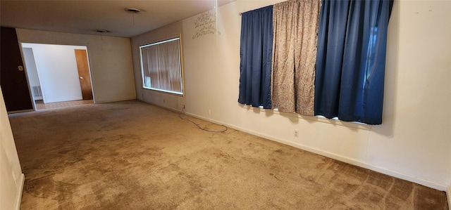 carpeted spare room with baseboards