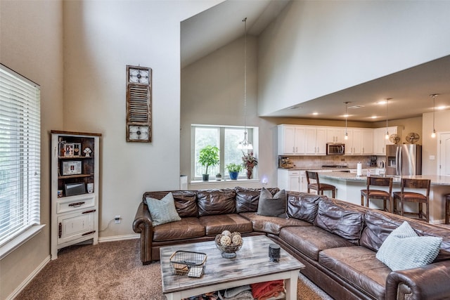 1821 Beacon Beach Way, Wylie, TX 75098 - living room featuring a high ceiling, dark colored carpet, baseboards, and a chandelier