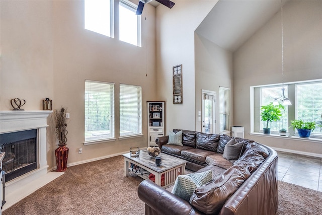 1821 Beacon Beach Way, Wylie, TX 75098 - carpeted living area featuring a high ceiling, healthy amount of natural light, ceiling fan, a fireplace, and baseboards