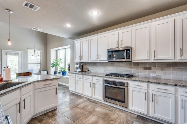 1821 Beacon Beach Way, Wylie, TX 75098 - kitchen with appliances with stainless steel finishes, backsplash, white cabinets, pendant lighting, and recessed lighting