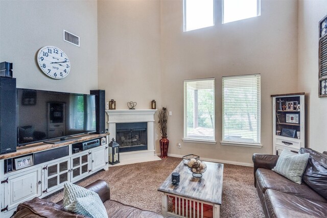 1821 Beacon Beach Way, Wylie, TX 75098 - living area with a high ceiling, carpet, a fireplace with raised hearth, and baseboards