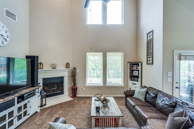 1821 Beacon Beach Way, Wylie, TX 75098 - carpeted living area with a high ceiling, plenty of natural light, a fireplace, and baseboards