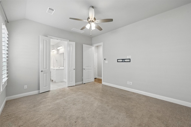 unfurnished bedroom featuring ceiling fan, ensuite bath, carpet, baseboards, and visible vents