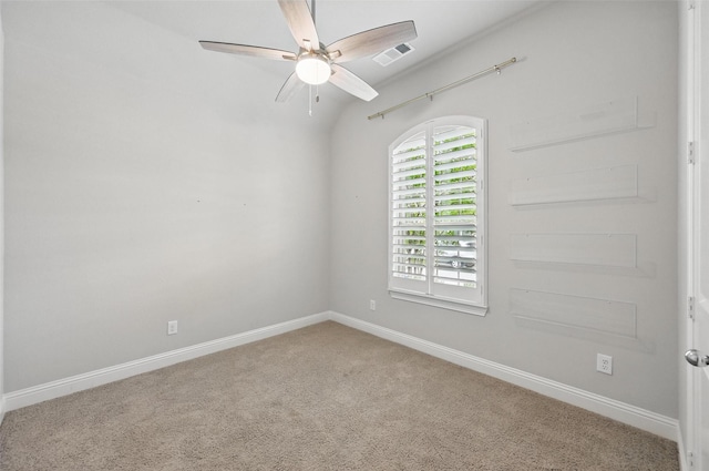carpeted empty room with baseboards, ceiling fan, and visible vents
