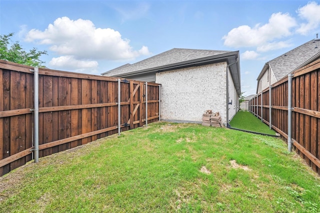 view of yard with a fenced backyard