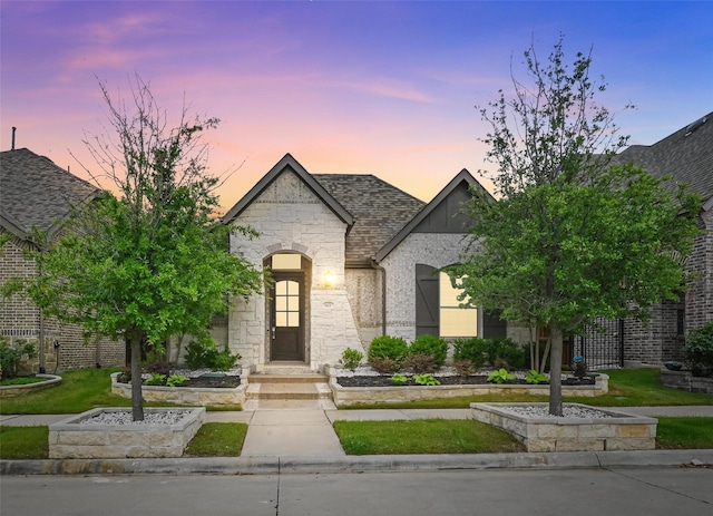 french country inspired facade with stone siding