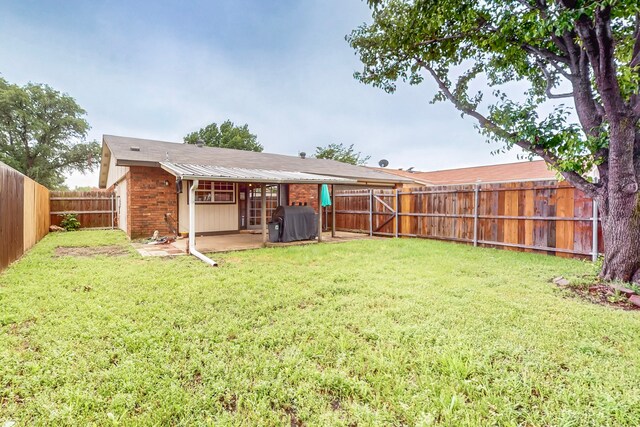 view of yard with a patio and a fenced backyard