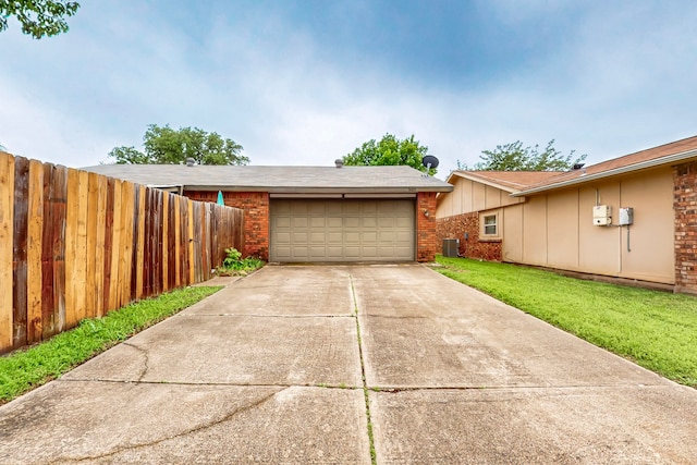 garage with fence and central AC unit