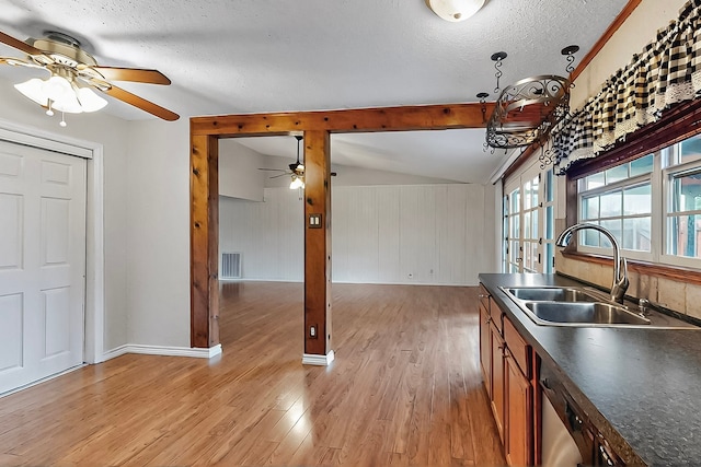 kitchen featuring ceiling fan, visible vents, dark countertops, and a sink