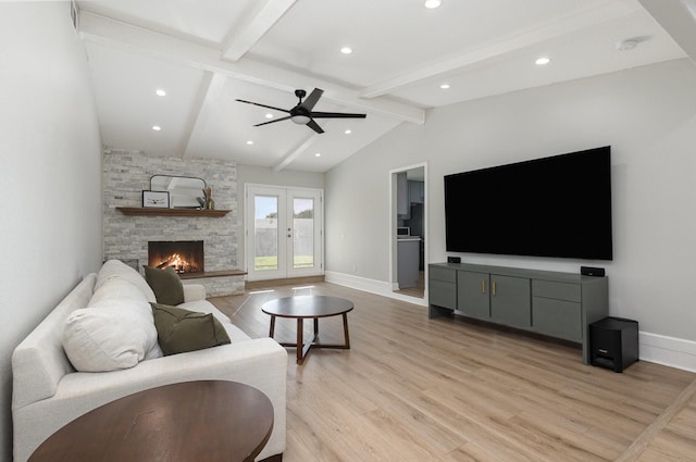 living area featuring light wood-type flooring, baseboards, a ceiling fan, a fireplace, and recessed lighting