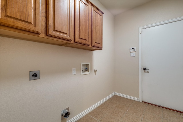 washroom featuring gas dryer hookup, washer hookup, hookup for an electric dryer, cabinet space, and baseboards