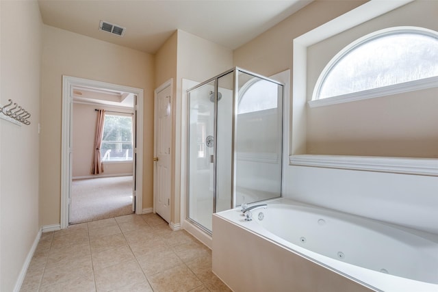 full bathroom featuring tile patterned floors, baseboards, a tub with jets, a shower stall, and visible vents