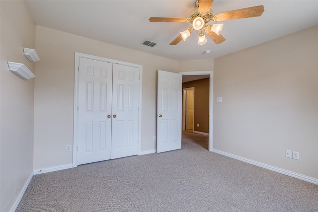 unfurnished bedroom featuring visible vents, carpet flooring, baseboards, and a closet