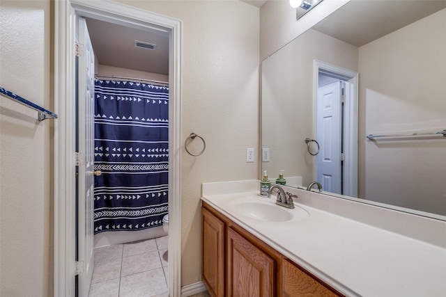 bathroom with vanity, toilet, tile patterned floors, a shower with shower curtain, and visible vents