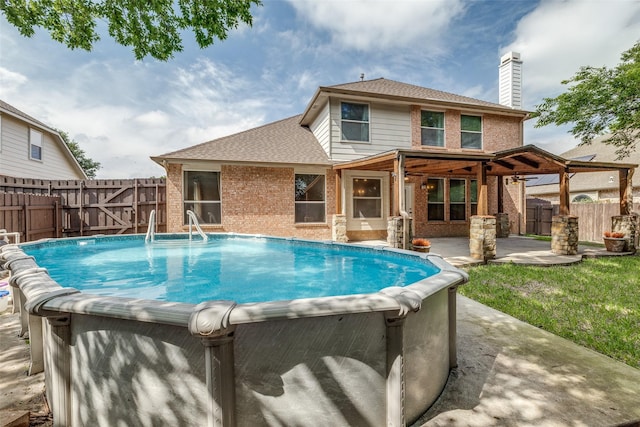 view of pool with a hot tub, a patio, a gate, and a fenced backyard