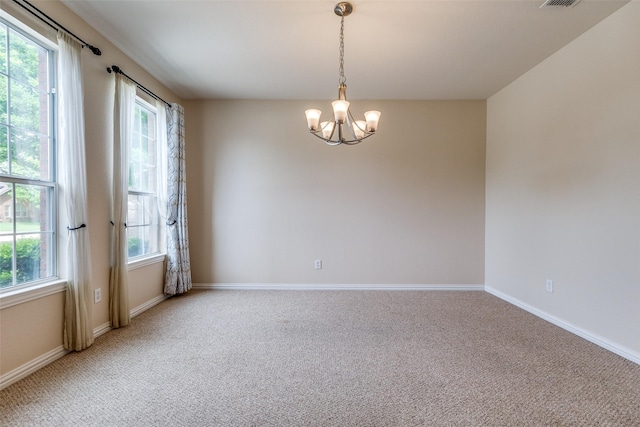 unfurnished room featuring baseboards, a notable chandelier, light carpet, and visible vents