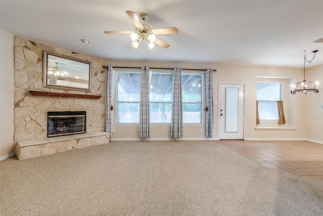 unfurnished living room featuring carpet floors, tile patterned floors, a healthy amount of sunlight, and a fireplace