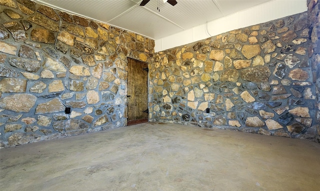 unfurnished room featuring unfinished concrete floors and ceiling fan