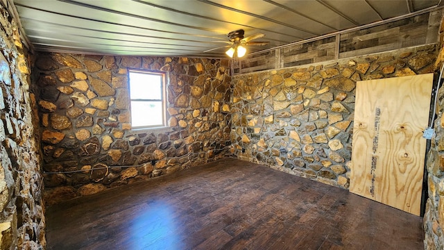 spare room featuring wood-type flooring and a ceiling fan