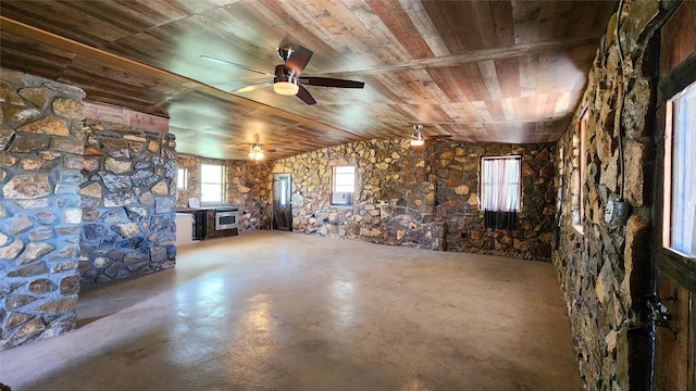 interior space with wooden ceiling, a ceiling fan, and finished concrete floors