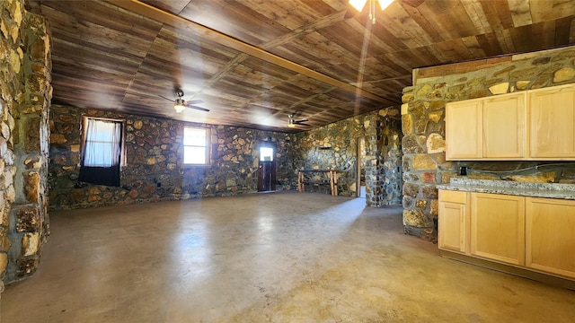 basement featuring wood ceiling and ceiling fan