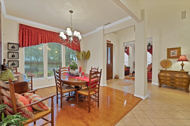 dining area with visible vents, ornamental molding, light tile patterned floors, and an inviting chandelier