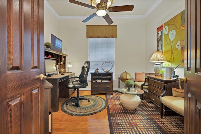 office space with baseboards, ceiling fan, ornamental molding, and wood finished floors