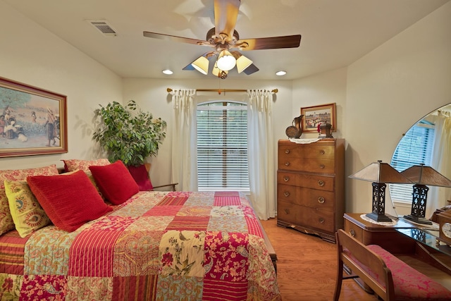 bedroom featuring recessed lighting, ceiling fan, visible vents, and light wood-style floors