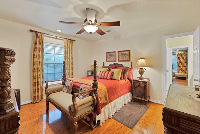 bedroom with baseboards, a ceiling fan, light wood finished floors, and visible vents