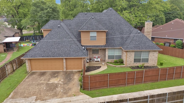 view of front of property with brick siding, a fenced backyard, and a front lawn