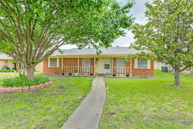 single story home featuring brick siding, cooling unit, and a front yard