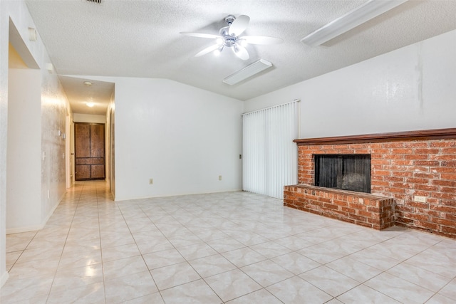 unfurnished living room featuring a ceiling fan, a textured ceiling, a fireplace, lofted ceiling, and light tile patterned flooring