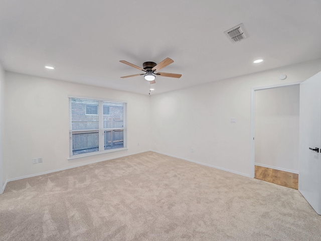 empty room with visible vents, a ceiling fan, carpet, and recessed lighting