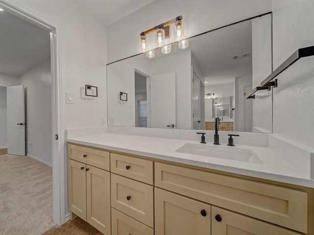 bathroom featuring vanity, baseboards, and visible vents