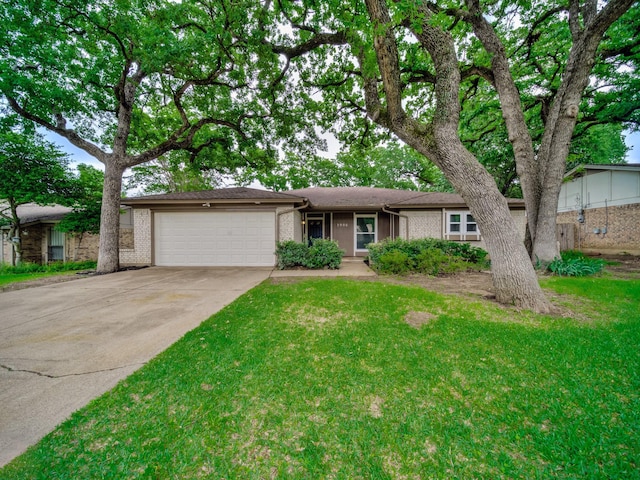 ranch-style home with brick siding, an attached garage, driveway, and a front yard