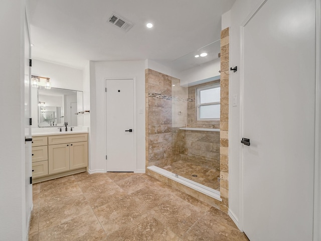 bathroom with visible vents, walk in shower, vanity, baseboards, and recessed lighting