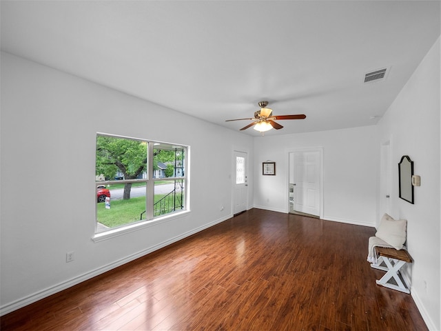 unfurnished living room featuring baseboards, a ceiling fan, wood finished floors, and visible vents
