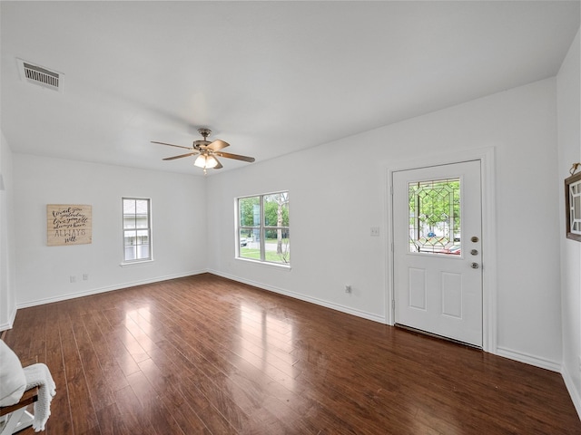 foyer entrance with visible vents, a ceiling fan, dark wood finished floors, and baseboards