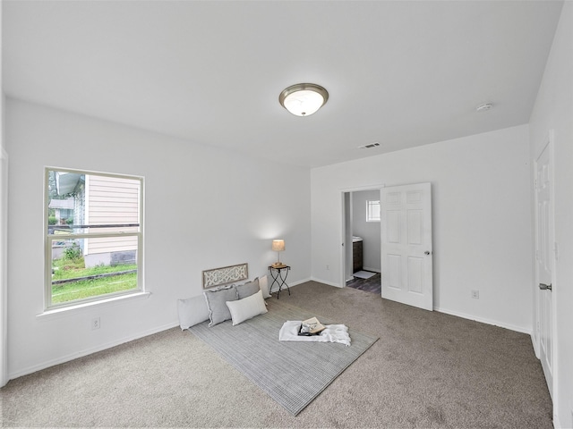 unfurnished room featuring carpet floors, baseboards, and visible vents