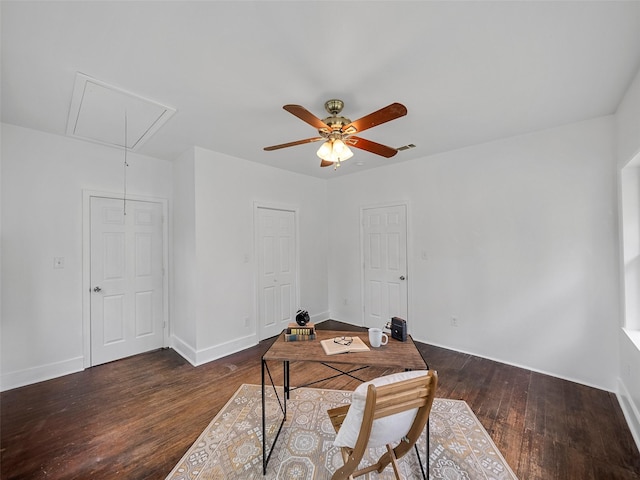 home office with a ceiling fan, attic access, visible vents, hardwood / wood-style flooring, and baseboards