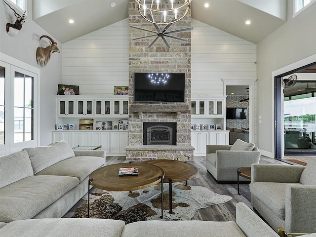 1018 Chaparrel Ln, Graford, TX 76449 - living room featuring high vaulted ceiling, a stone fireplace, wood finished floors, a chandelier, and recessed lighting