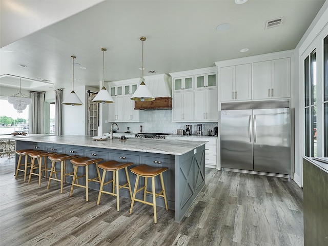 1018 Chaparrel Ln, Graford, TX 76449 - kitchen featuring built in refrigerator, custom exhaust hood, dark wood finished floors, and a large island