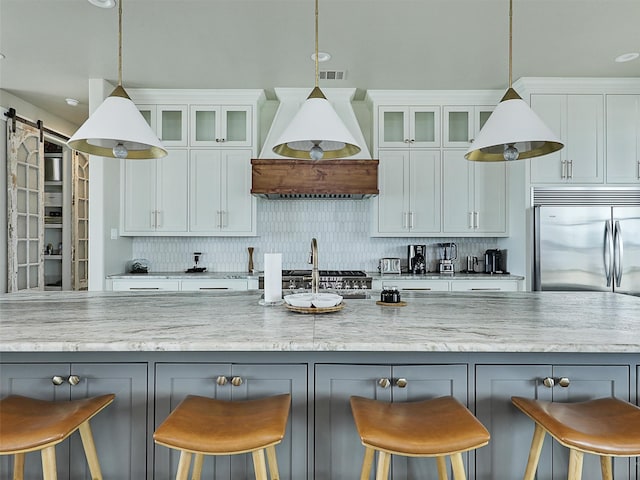 1018 Chaparrel Ln, Graford, TX 76449 - kitchen with premium range hood, tasteful backsplash, white cabinetry, and light stone counters