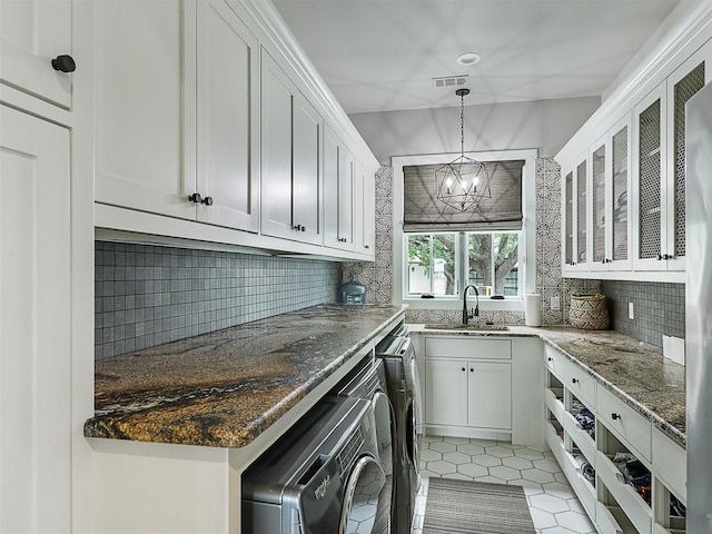 1018 Chaparrel Ln, Graford, TX 76449 - kitchen featuring a sink, separate washer and dryer, decorative backsplash, and white cabinets